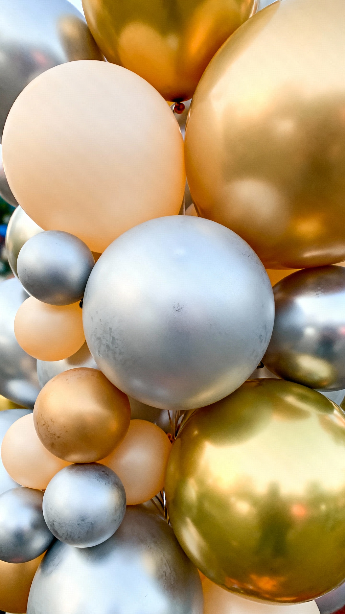 Closeup of mixed-size matte and metallic balloons cluster