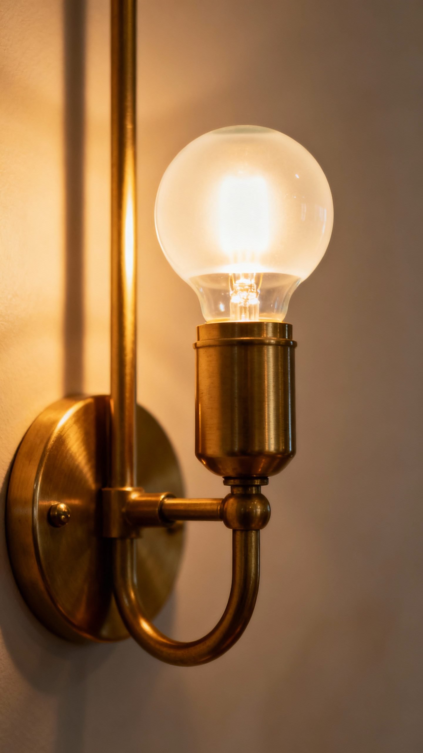 Closeup of warm 2700K LED bulb in brass sconce
