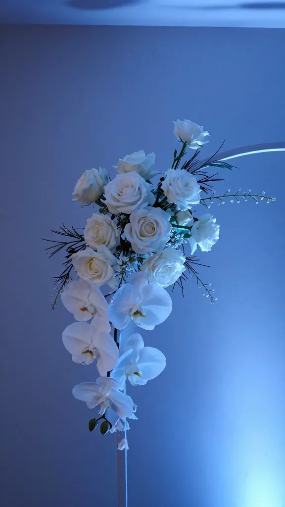 closeup of cool blue uplighting on a minimalist wedding arch bouquet