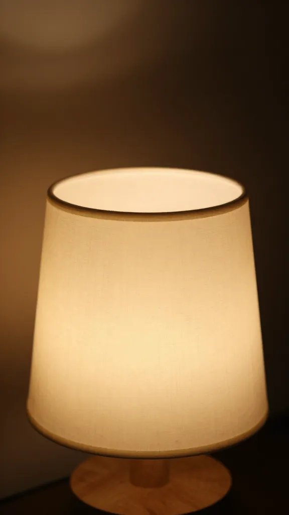 closeup of a warm dimmer-lit table lamp glow