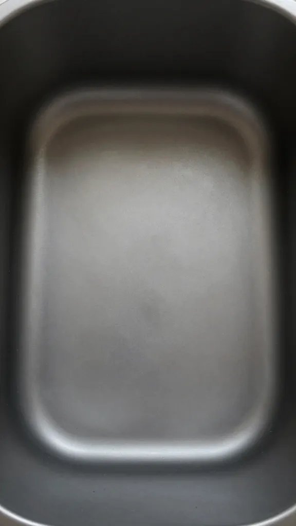 Closeup of a lone low arrangement with ample surrounding air in a sleek container
