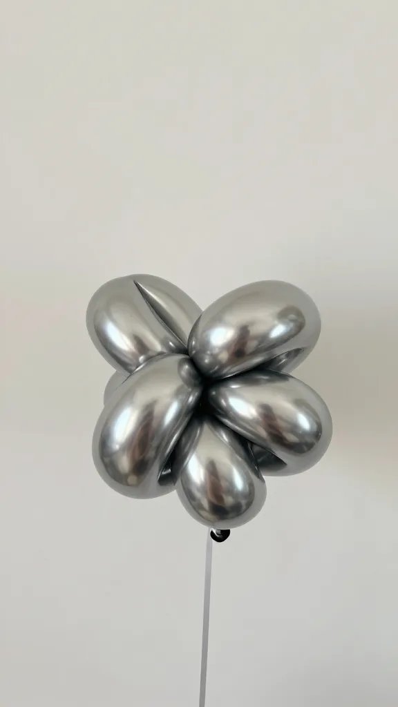 closeup of a lone metallic balloon knot on string